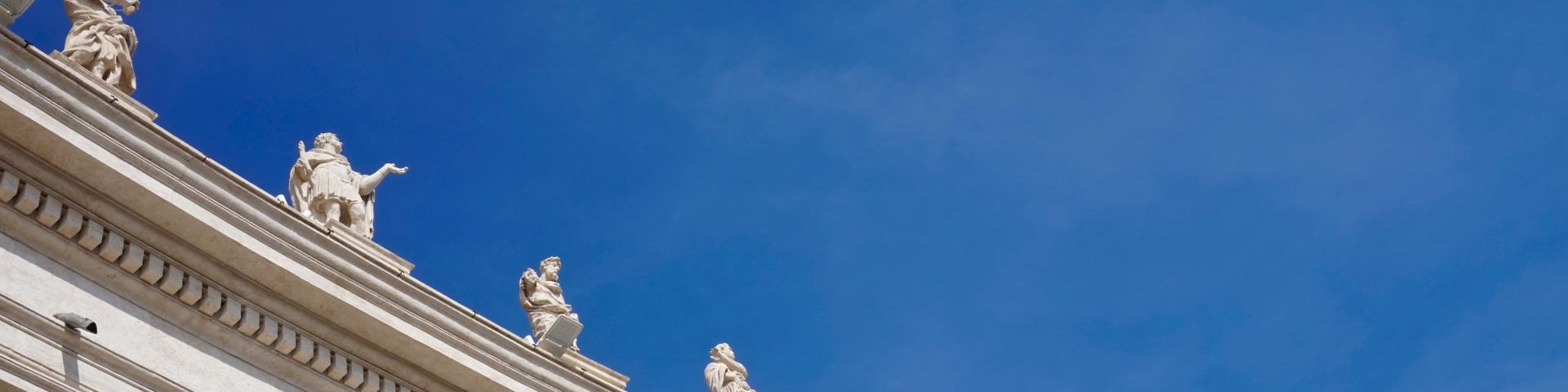 Vatican sculptures of saints with blue sky in the background 