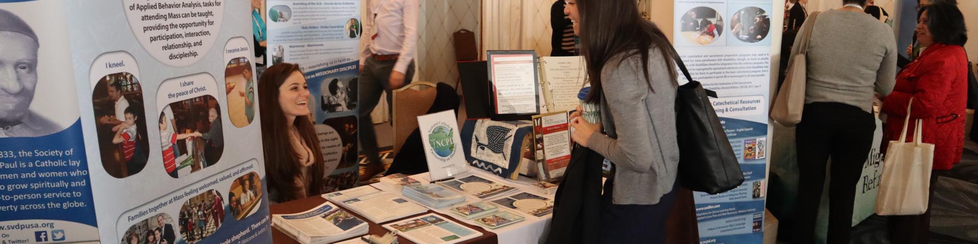Staff networking and educating at NCPD exhibit table 
