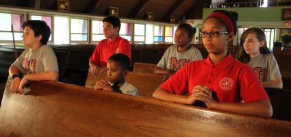 Students praying at a Church 