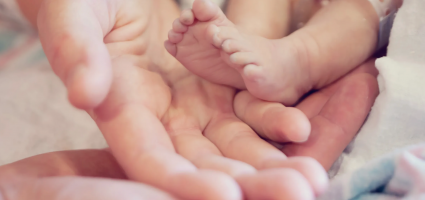 baby's feet and mother's hand 