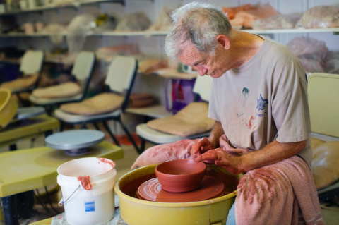 Martin making pottery with a pottery wheel 