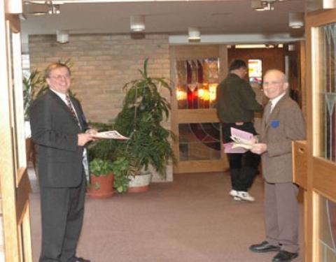 Ushers greeting at church door.