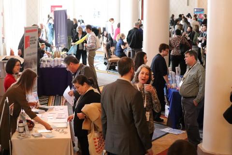 Picture of people networking in an exhibit hall at the Catholic Social Ministry Gathering 